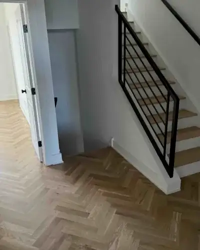 Refinished white oak herringbone hardwood floor and stairs
