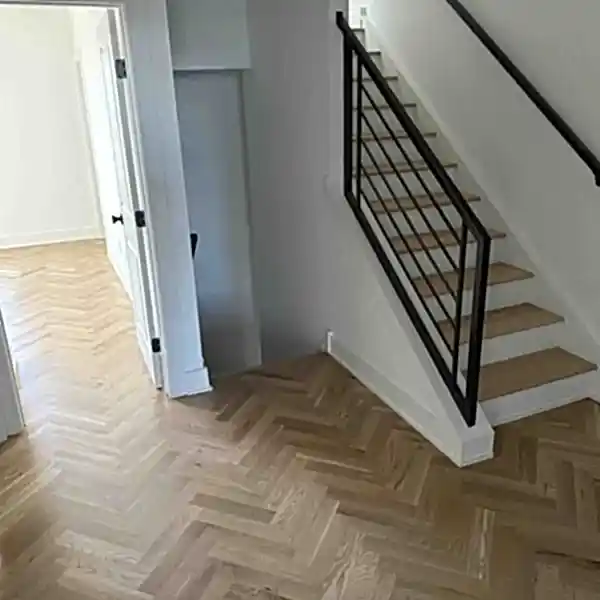 Refinished white oak herringbone hardwood floor and stairs