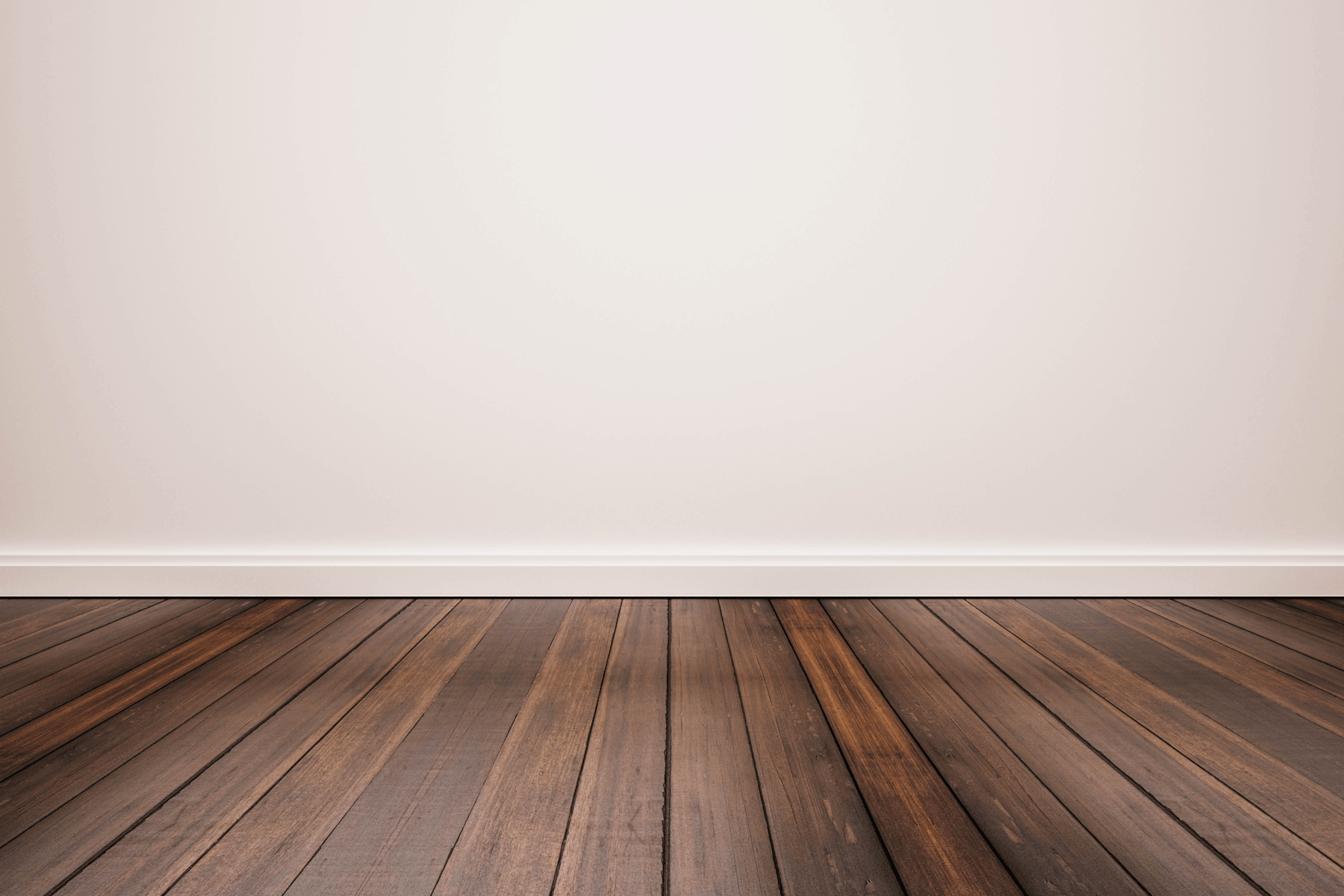 Empty-room-with-a-white-wall-baseboard-and-dark-hardwood-plank-flooring