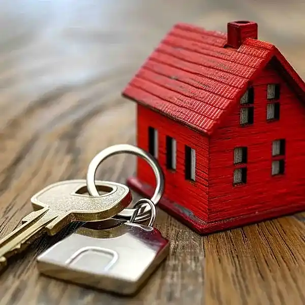 little-red-house-with-keys-on-top-of-wooden-surface