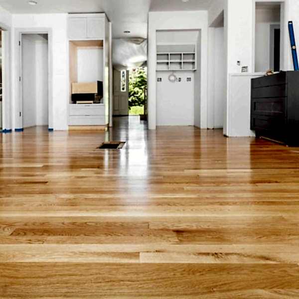Newly refinished hardwood floors in a bright home interior during renovation.