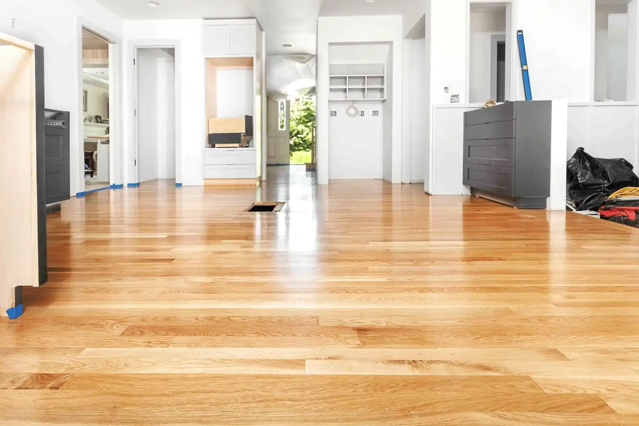 Newly refinished hardwood floors in a bright home interior during renovation.